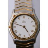 A ladies Ebel watch with 18ct gold bezel, gold tone roman numerals and hands and a two tone strap