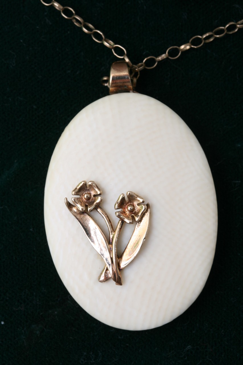 A 9ct gold and ivory pendant.