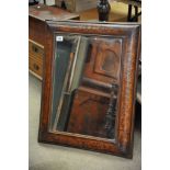 An early 19th Century continental inlaid walnut cushioned framed mirror, possibly a later mirror