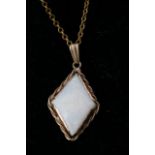 A 9ct gold pendant set with a diamond shaped opal,