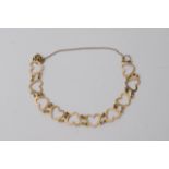 A 9ct gold bracelet in the form of linked hearts,