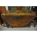 A large late 18th century oak gateleg table the twin flap top on turned legs.