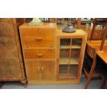 An Art Deco bureau display cabinet, the fall front above drawers and cupboards with a stepped top.