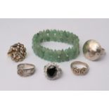 A jade bracelet comprised of spherical beads and diamond shaped pieces of jade alongside a