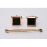 A pair of 9ct gold cugg links set with black squar