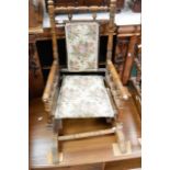 A Victorian walnut child's rocking chair with turn