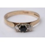 A 9ct gold ring set with two diamonds and a sapphi