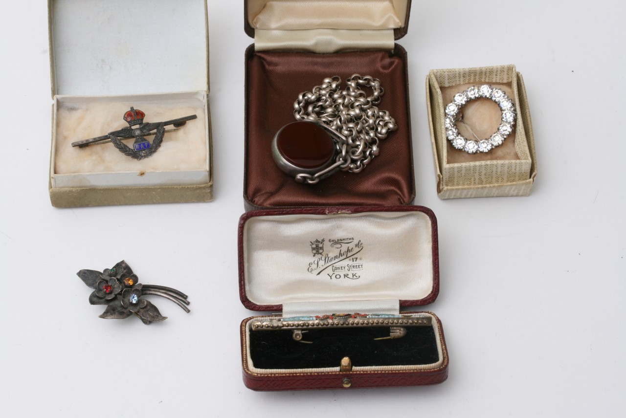 A silver chain with silver pendent and four brooch