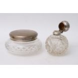 A silver topped scent bottle and a silver topped tidy jar, (2)