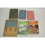 A collection of old books including an early 'From Russia with love' by Ian Fleming, 'Alice's