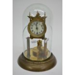 A brass clock under a glass dome, approx 27.5cm.