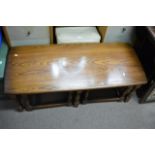 A nest of three Ercol type tables comprising of one long table and two smaller half sized tables,