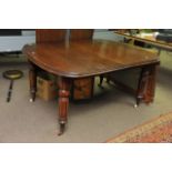 A Victorian Mahogany extending dining table, the oval top with two extra leaves. turned and fluted