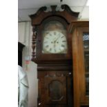 An eight day longcase clock with painted dial depicting buildings and having Roman numerals,