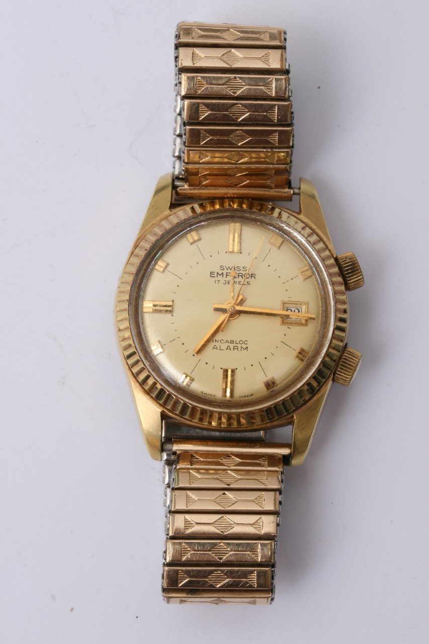 A gold tone Swiss Emperor 17 jewel wristwatch with baton numerals and date aperture.