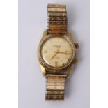 A gold tone Swiss Emperor 17 jewel wristwatch with baton numerals and date aperture.