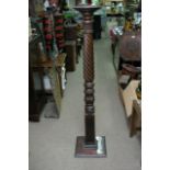 A carved wood torchere