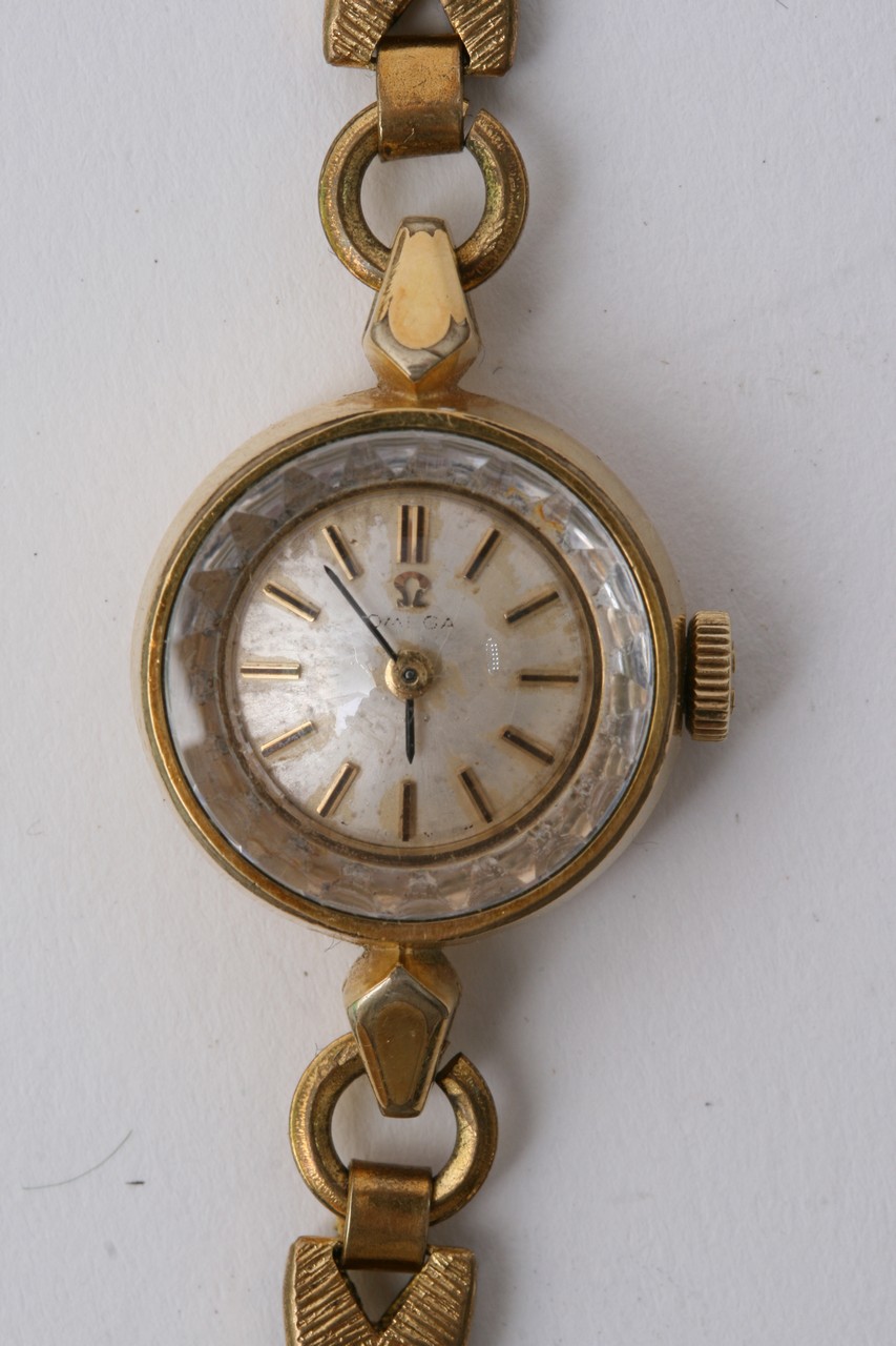 A Ladies Gold Tone Omega Wrist Watch with pearles