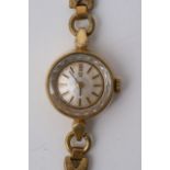 A Ladies Gold Tone Omega Wrist Watch with pearles