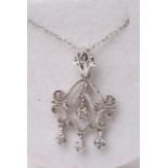 A white gold pendant with four diamonds on chain. Necklace comes in a small red box