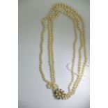 A 9ct yellow gold three row necklace, graduating cultured pearls, the clasp set with pearls