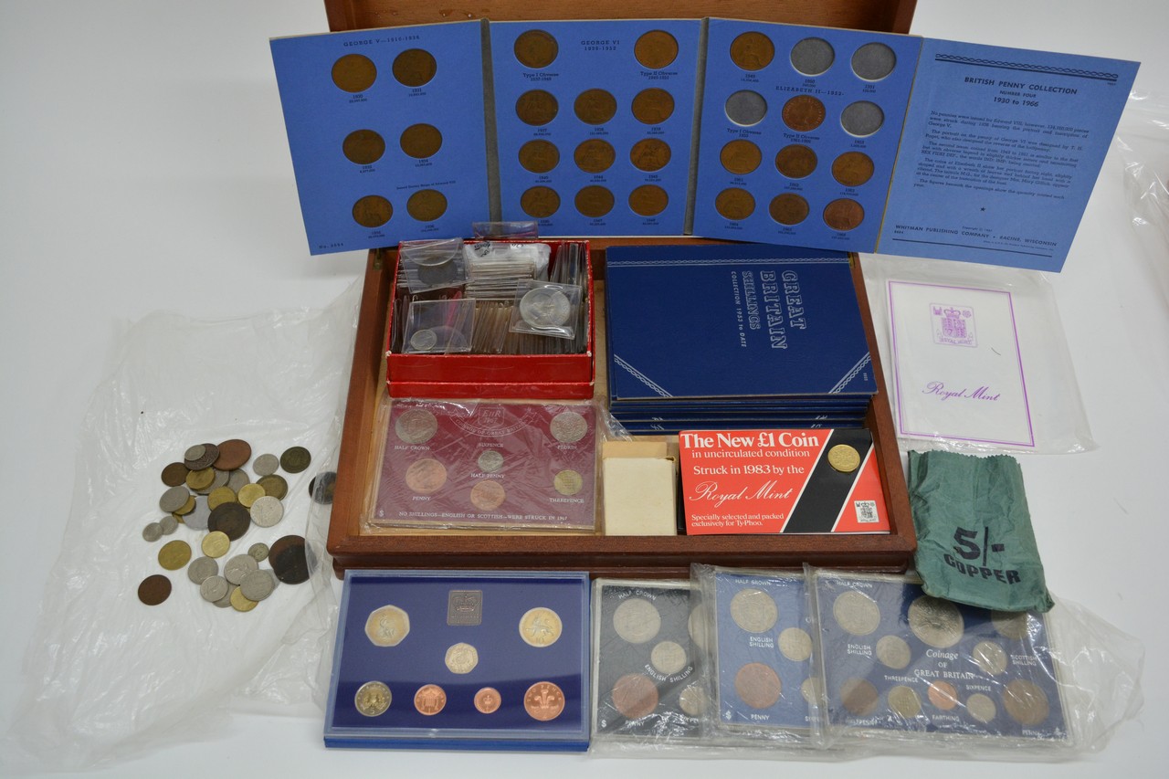 A case of various coins,loose and in sets plus coi