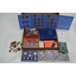 A case of various coins,loose and in sets plus coi