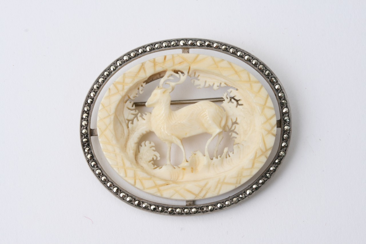 An ivory and silver Scottish brooch depicting a de