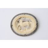 An ivory and silver Scottish brooch depicting a de