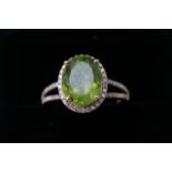 A yellow gold and diamond ring set with an oval cut peridot approx 4.41ct diamonds approx 0.40ct