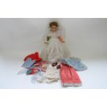 An interesting 1960s doll, dressed as a bride, with numerous other outfits and shoes