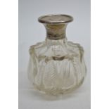 A silver topped scent bottle with a hinged cap Sheffield hallmarks 1936.