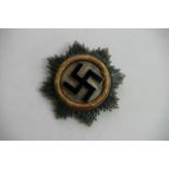 A German WW2 Style Deutschen Kreuz in gold with No