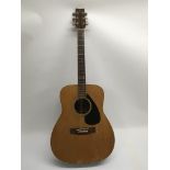 A Yamaha FG180 acoustic guitar, circa 1974-77. The