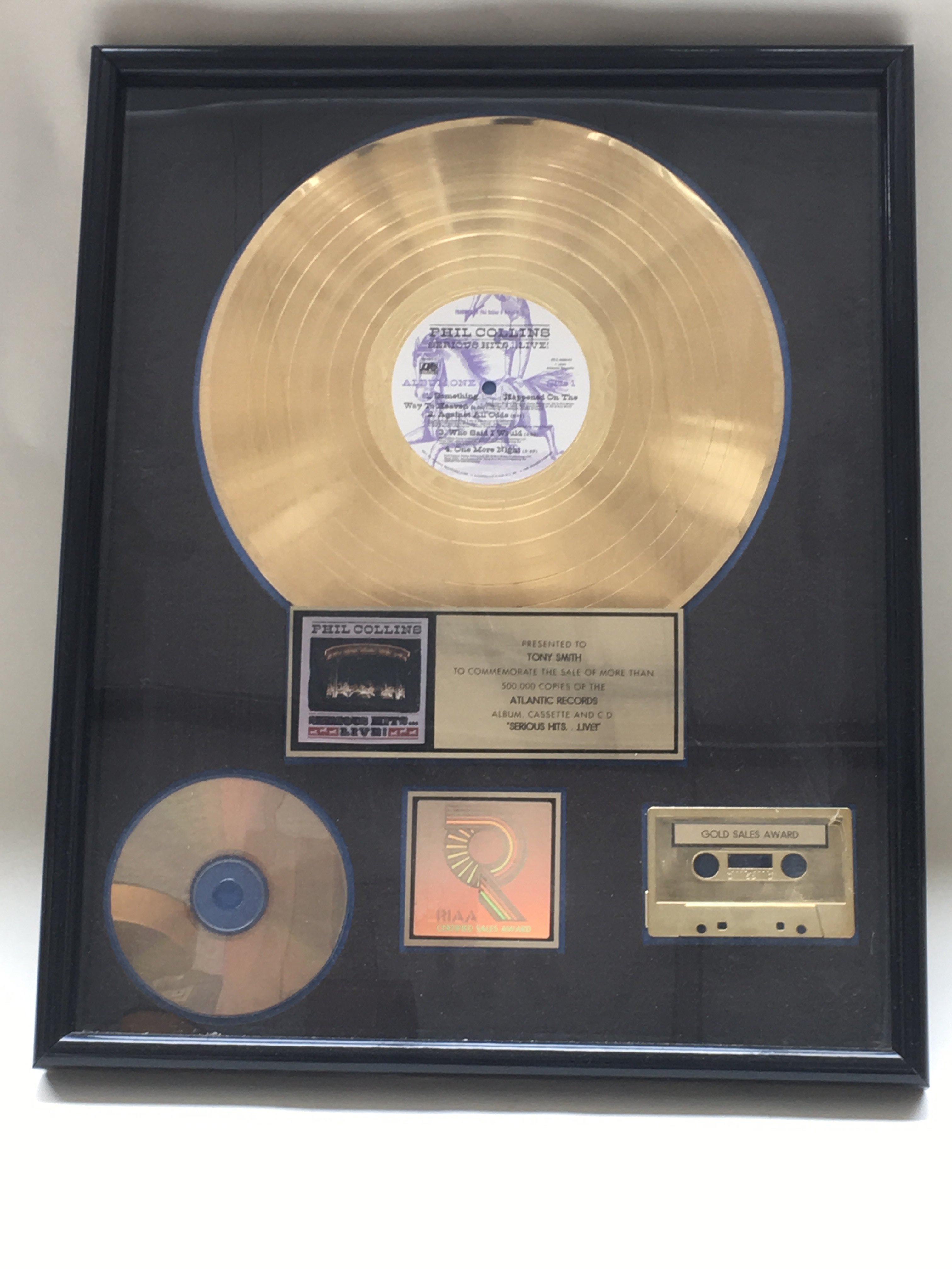 A framed presentation Phil Collins gold disc to co