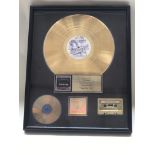 A framed presentation Phil Collins gold disc to co