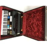 A cased Duovox Galanti electric accordion with sep