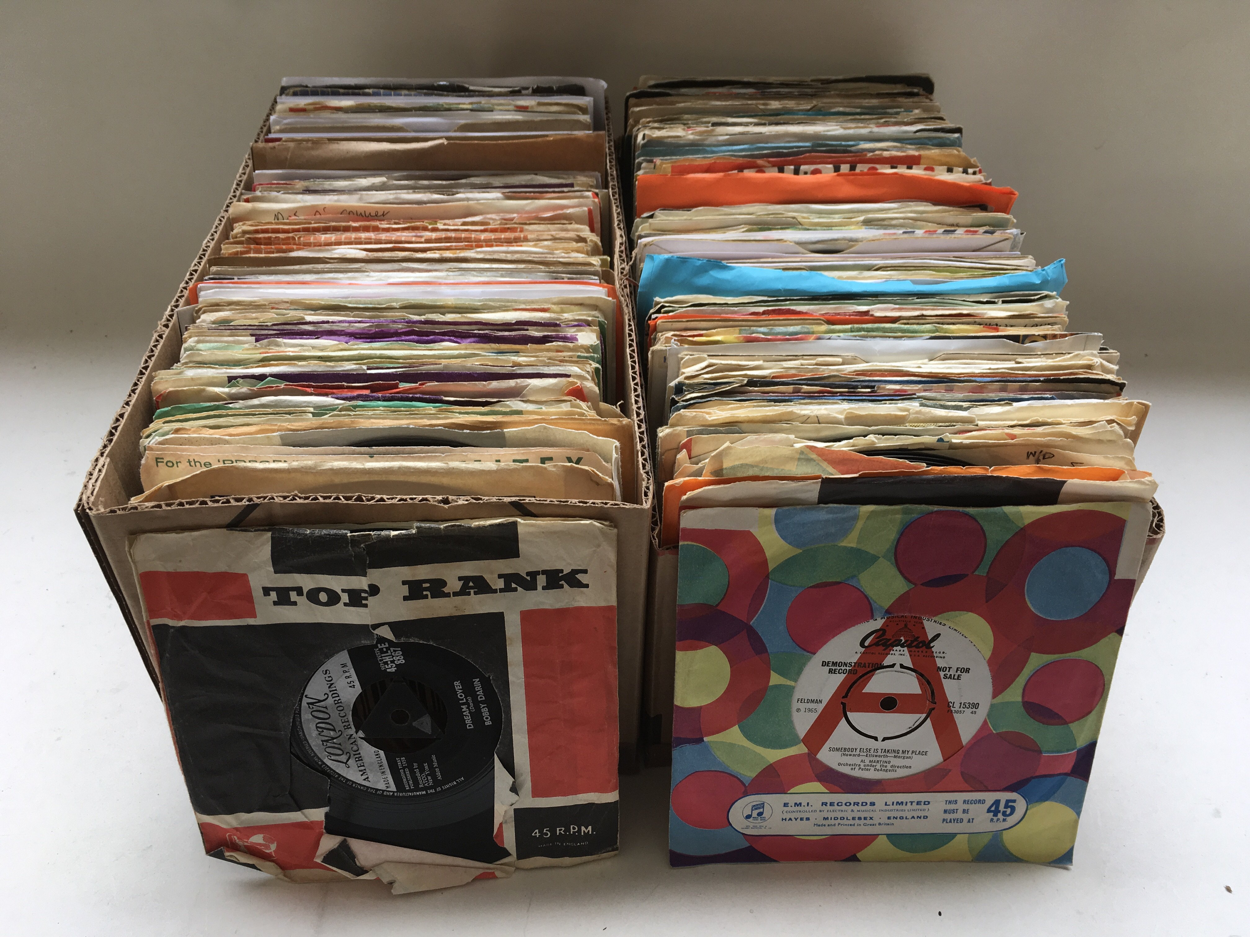 Two boxes of 7 inch singles by various artists fro