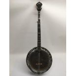 A Hondo banjo fitted with a Remo weather king banj