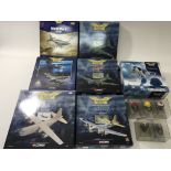 A collection of 7 boxed Corgi Aviation Archive model aircraft together with 5 cased miniature pilots