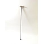A silver handled black walking stick with folate d