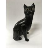 A Bretby pottery cat with glass eyes, approx 23.5c