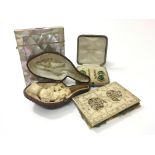 A mother of pearl card case, an Oriental carved ne