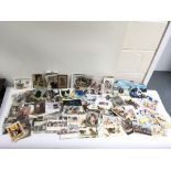 A shoebox containing a collection of postcards inc