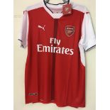 An Arsenal football shirt signed by Mesut Ozil wit