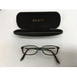 A pair of cased Gucci glasses