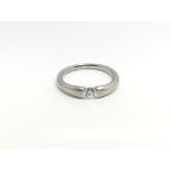 An 18ct white gold ring inset with a single diamond, total weight approximately 5.8 grams, ring size