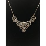 A silver Art Deco marquisite necklace with bow shaped influence.