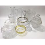 A collection of cut glass to includes jugs, a biscuit barrel and decanters.