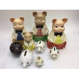 A collection of 9 ceramic piggy banks.